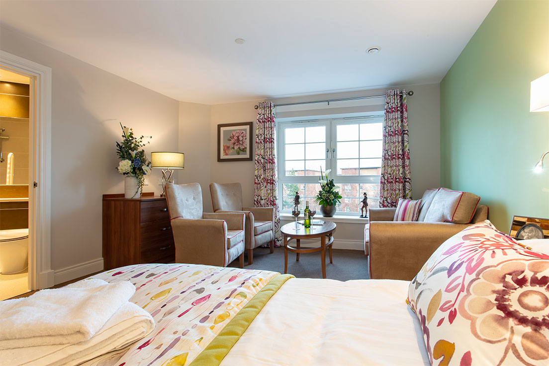 double bed with sofas and armchairs