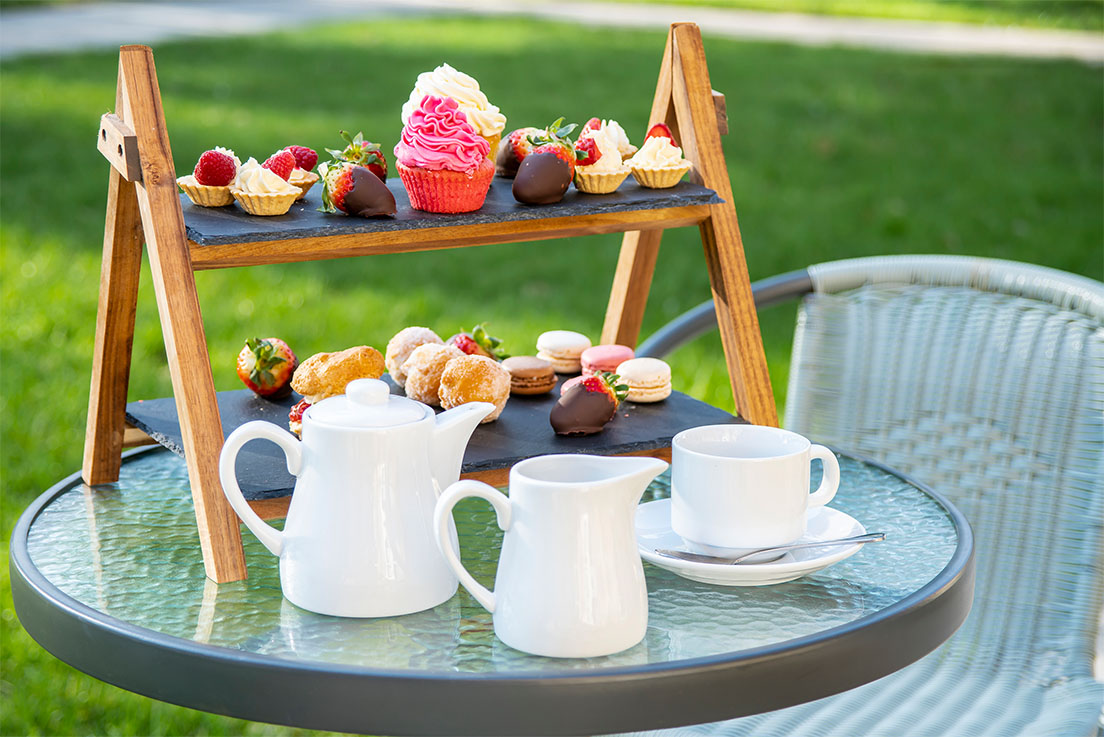 afternoon tea spread with cakes and tea
