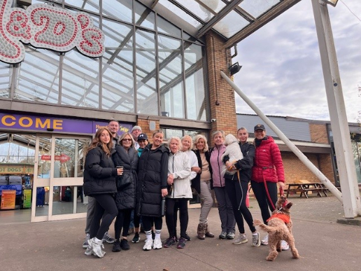 Bothwell Castle Care Home staff, residents’ families, and pets walking along a scenic path at Strathclyde Country Park during a 10k sponsored walk for Make-A-Wish UK