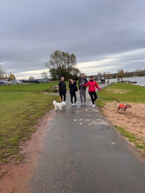 Bothwell Castle Care Home staff, residents’ families, and pets walking along a scenic path at Strathclyde Country Park during a 10k sponsored walk for Make-A-Wish UK