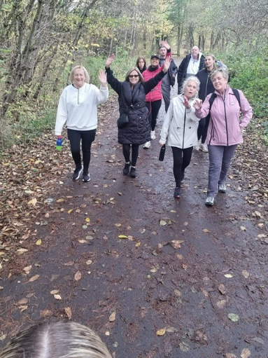 Bothwell Castle Care Home staff, residents’ families, and pets walking along a scenic path at Strathclyde Country Park during a 10k sponsored walk for Make-A-Wish UK