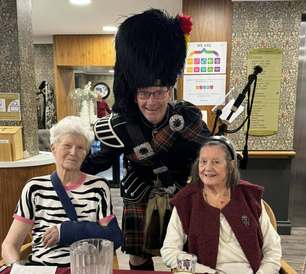 Greg the piper with residents