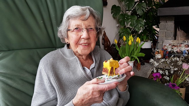 elderly woman eating some cake