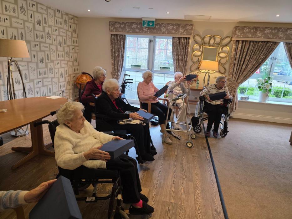 older ladies sat down doing yoga exercises