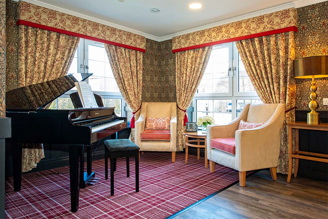 room with armchairs and grand piano