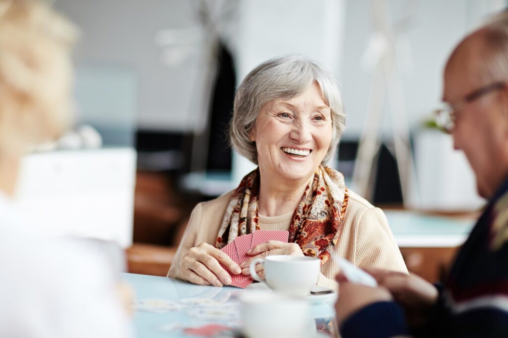 elderly woman smiling in a care home activity