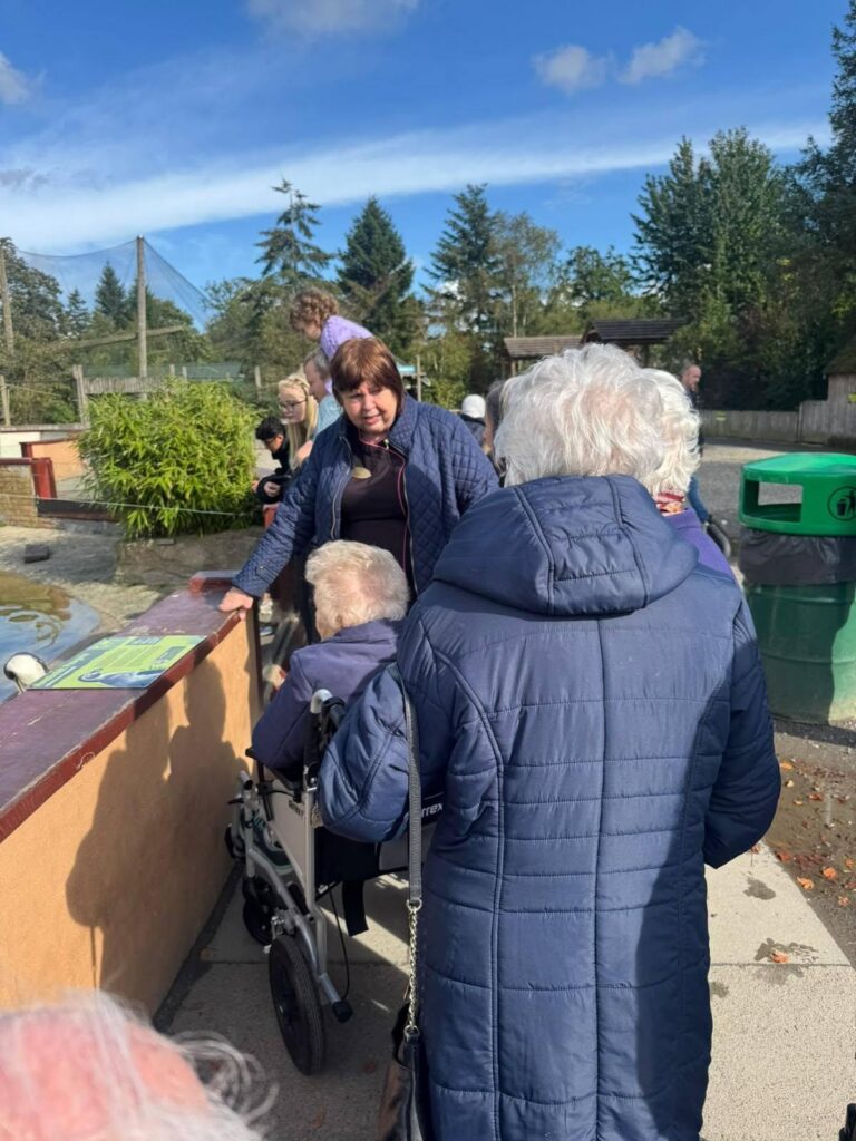 care home residents enjoying a zoo outing