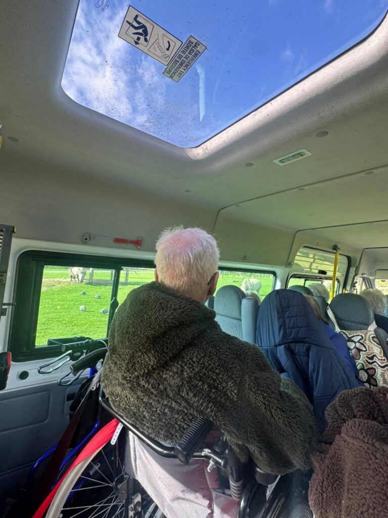 elderly man in a wheelchair on a minibus